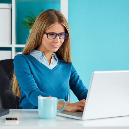 Young business woman working in modern office on computer